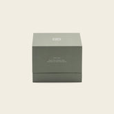 Soy wax ceramic candle by Italic in a minimalist white ceramic holder with a lit wick and a soft glow.