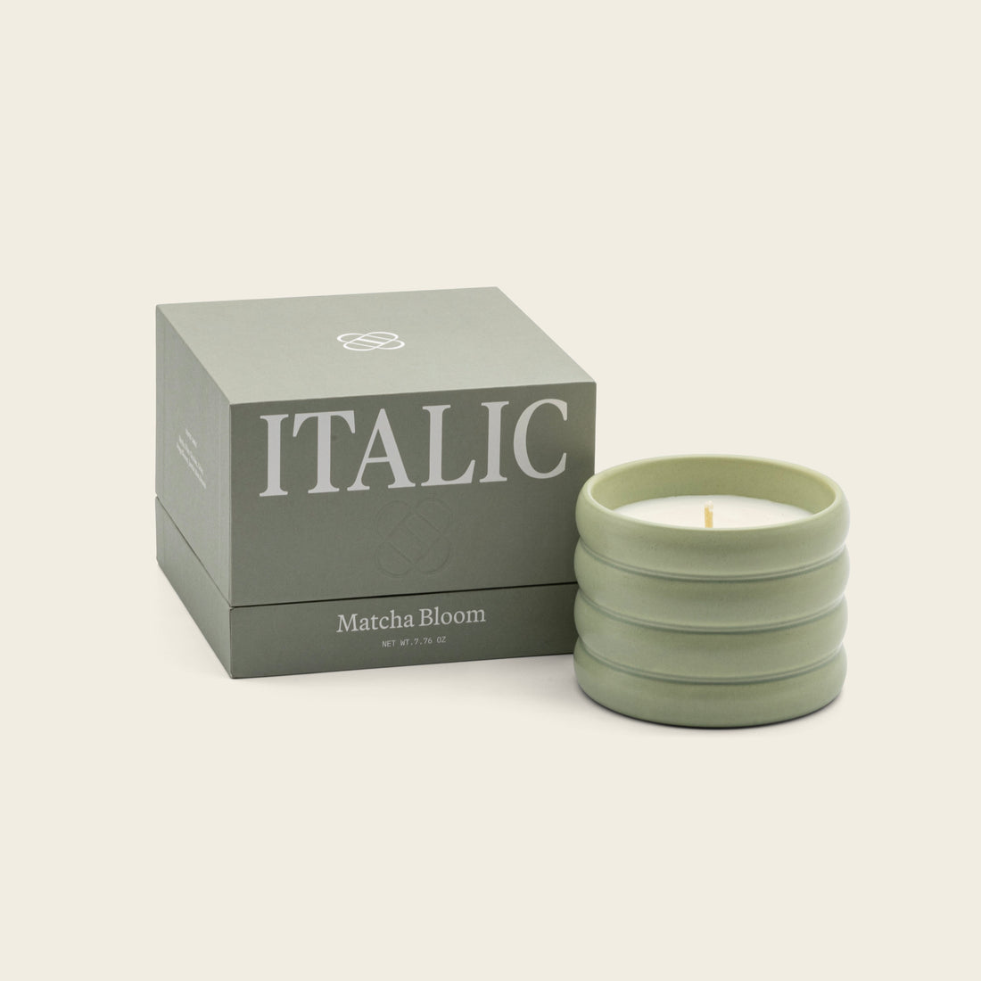 Soy wax ceramic candle by Italic with a minimalist white ceramic holder and a lit wick, emitting a warm, inviting glow.