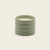 Italic soy wax ceramic candle with a white ceramic holder and a lit wick, highlighting a cozy and minimalist design.