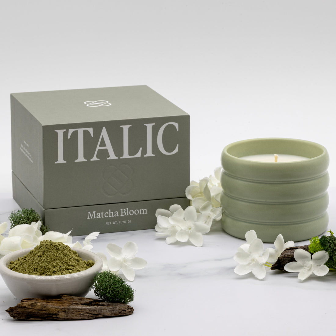 Soy wax ceramic candle by Italic with a simple, elegant white ceramic holder and a lit flame, creating a cozy ambiance.
