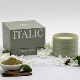 Soy wax ceramic candle by Italic with a simple, elegant white ceramic holder and a lit flame, creating a cozy ambiance.