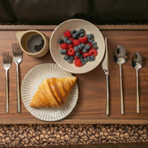 Italic Emilia mirror finish 20-piece flatware set featuring sleek forks, knives, spoons, and teaspoons for elegant dining.