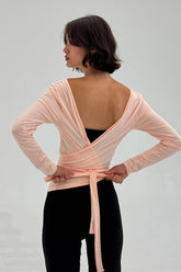 Powder pink ballerina wrap top by findmenowthelabel, featuring a soft, fitted design with long sleeves and a stylish wrap detail.