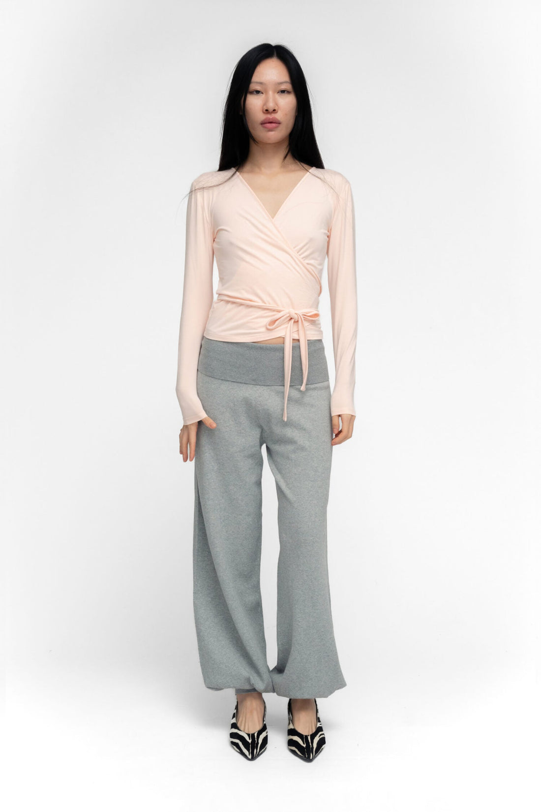 FindMeNowTheLabel ballerina wrap top in powder pink, featuring soft fabric and a feminine wrap design, displayed on a hanger.