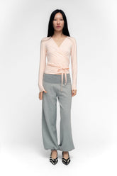 FindMeNowTheLabel ballerina wrap top in powder pink, featuring soft fabric and a feminine wrap design, displayed on a hanger.