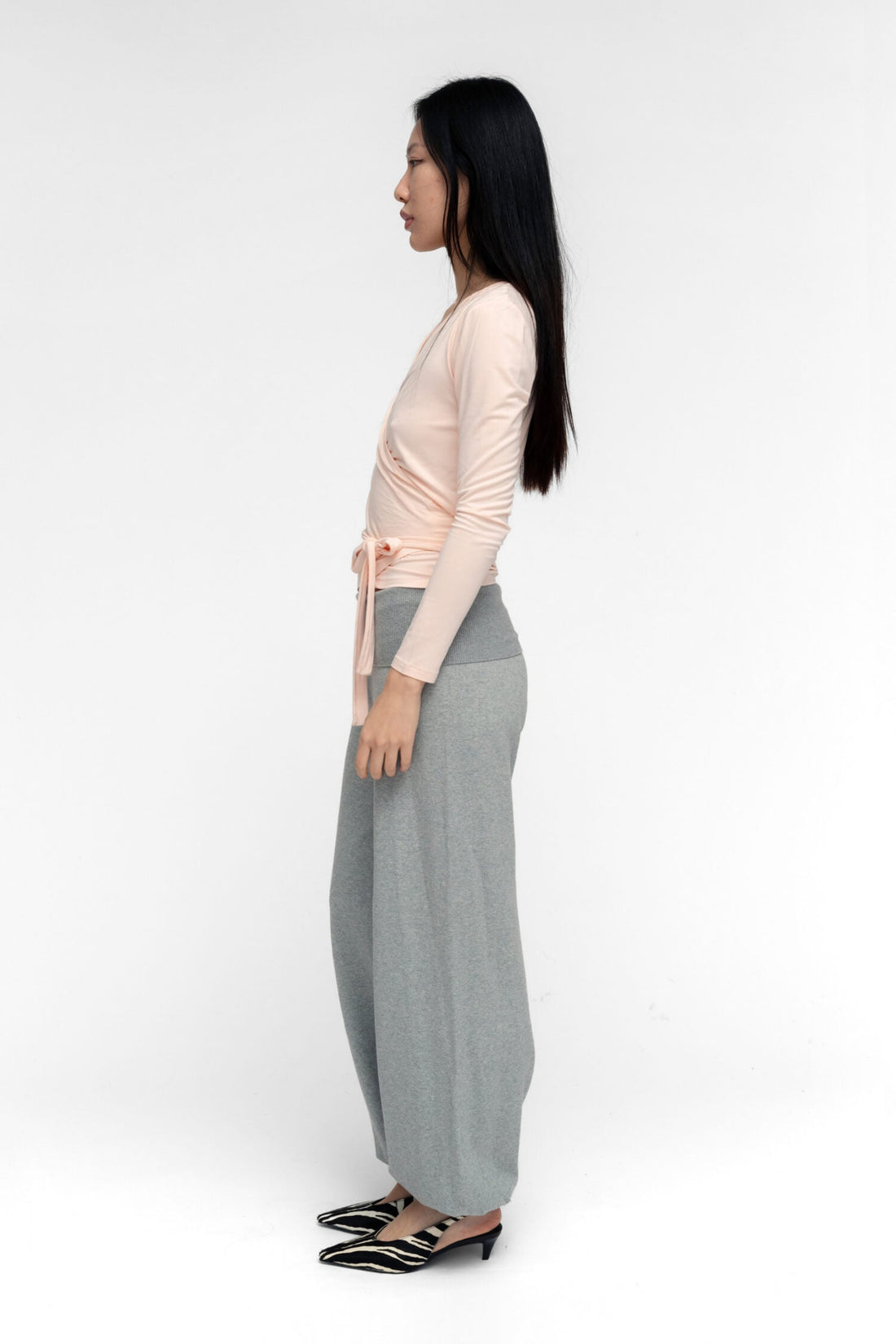 FindmeNowTheLabel ballerina wrap top in powder pink, featuring a fitted silhouette and soft, flowy fabric.