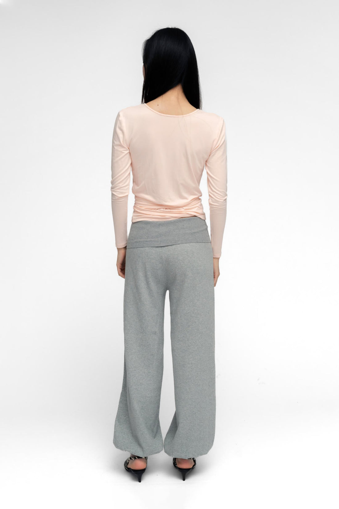 FindmeNowTheLabel ballerina wrap top in powder pink, soft fabric, with a fitted silhouette and delicate wrap design.