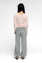 FindmeNowTheLabel ballerina wrap top in powder pink, soft fabric, with a fitted silhouette and delicate wrap design.