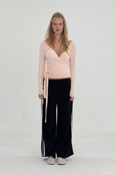 FindmeNowTheLabel ballerina wrap top in powder pink, soft fabric with a fitted silhouette and delicate wrap design.