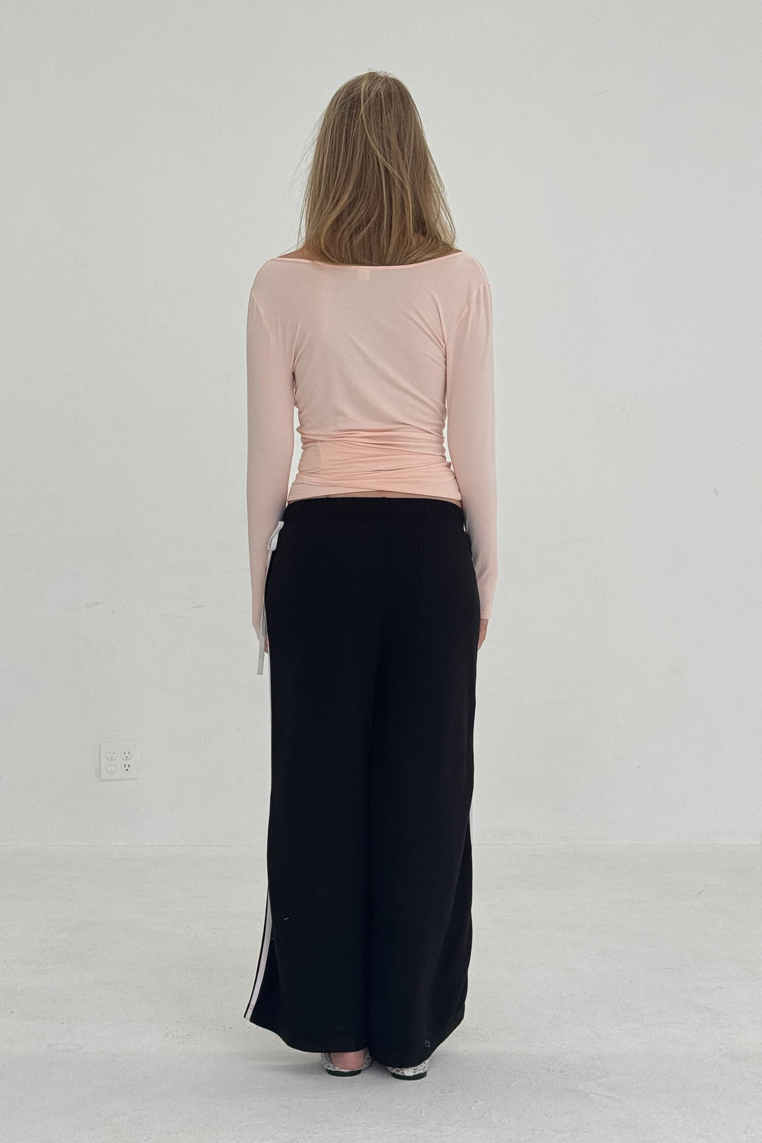 FindmeNowTheLabel ballerina wrap top in powder pink, featuring a slim fit design with long sleeves and a flattering wrap style.