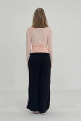 FindmeNowTheLabel ballerina wrap top in powder pink, featuring a slim fit design with long sleeves and a flattering wrap style.