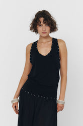Black YUNA tank top by findmenowthelabel, close-up of sleeveless top with smooth fabric and simple design.