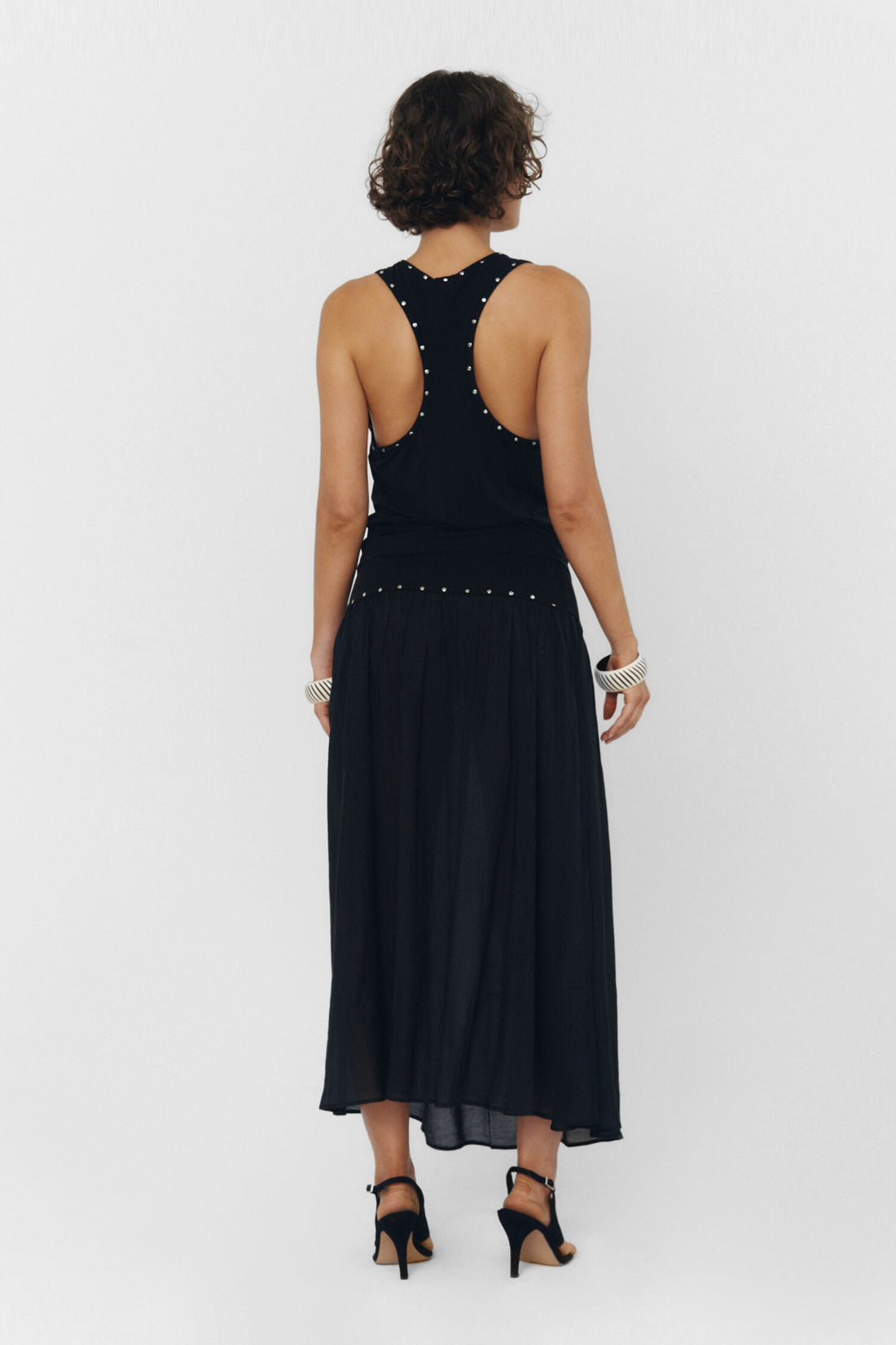 Black YUNA tank top by findmenowthelabel, showcased on a hanger with a simple, sleeveless design and soft fabric texture.