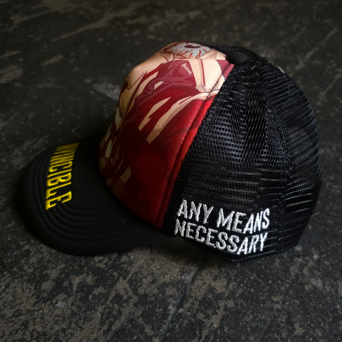 Black Face Smasher Trucker Hat by Any Means Necessary Clothing with mesh back and bold front design.