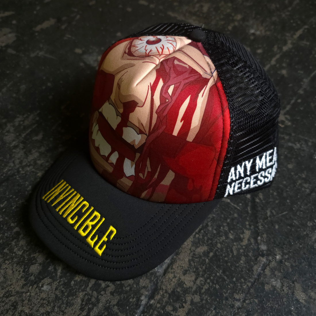 Black Face Smasher Trucker Hat by Any Means Necessary Clothing with a front graphic and mesh back for breathability