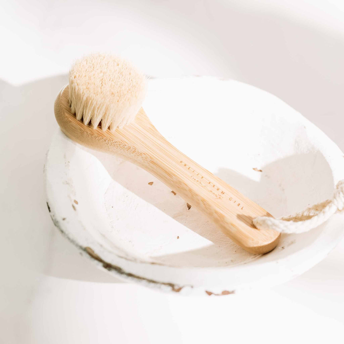 Pretty Farm Girl dry face brush for skincare, with soft bristles and ergonomic handle, designed for gentle facial cleansing.