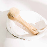 Pretty Farm Girl dry face brush for skincare, with soft bristles and ergonomic handle, designed for gentle facial cleansing.