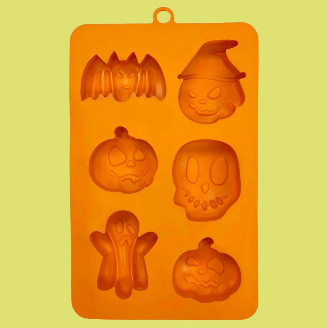 Orange silicone Halloween pet treat mold by Farm To Pet, featuring spooky shapes for homemade pet snacks.