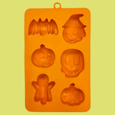 Orange silicone Halloween pet treat mold by Farm To Pet, featuring spooky shapes for homemade pet snacks.