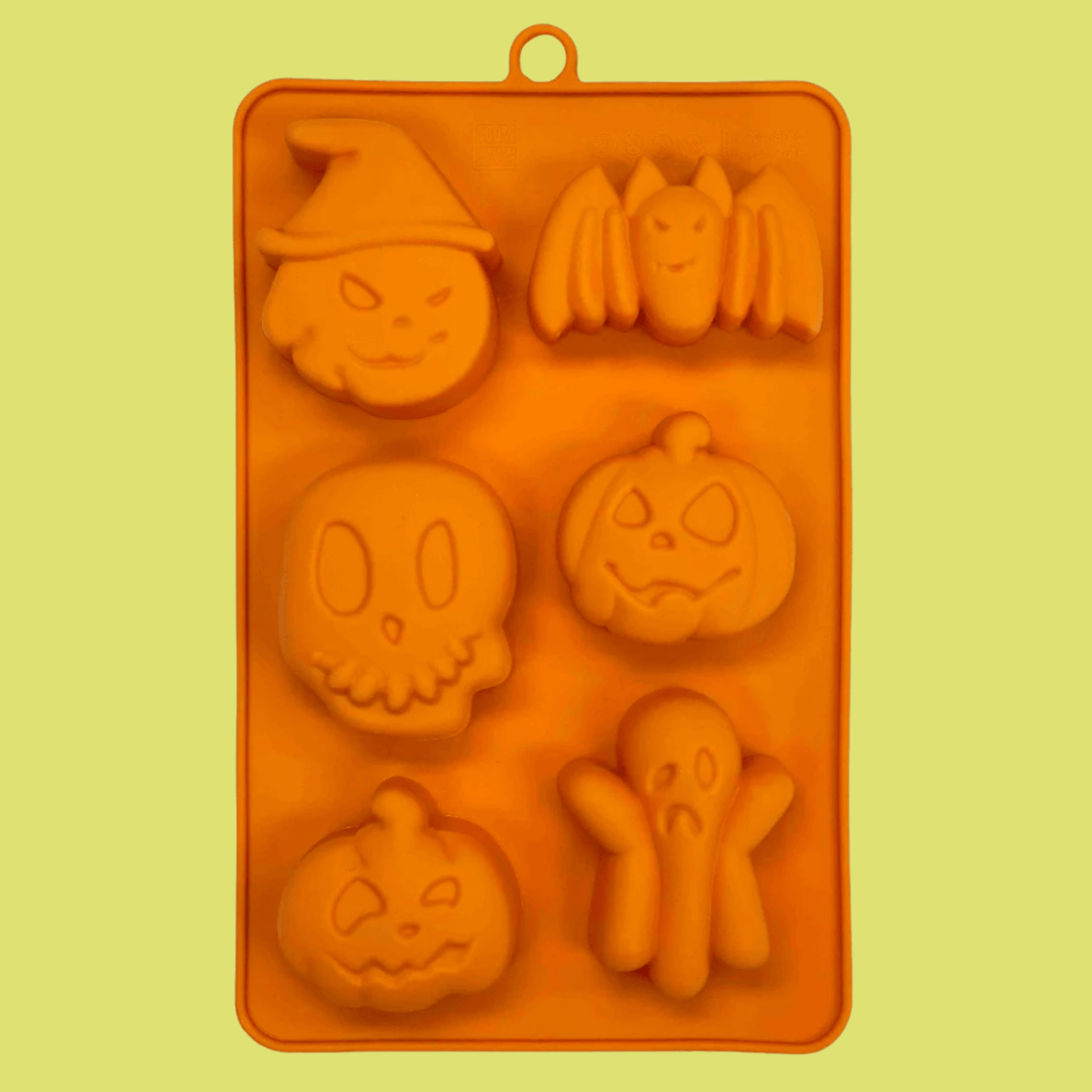 Orange silicone Halloween pet treat mold by Farm To Pet featuring spooky pumpkin and ghost shapes for making pet treats.