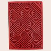 Close-up of Farm To Pet lick mat with red hearts, designed for cats and small dogs to lick and comfort.