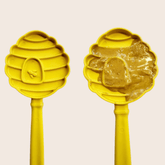 Close-up of Farm To Pet Lick Stick, a yellow beehive-shaped interactive dog training toy designed for engaging play.