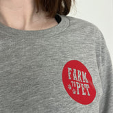 Gray Farm to Pet logo T-shirt featuring a front view, showcasing the casual fit and branded design on soft fabric.