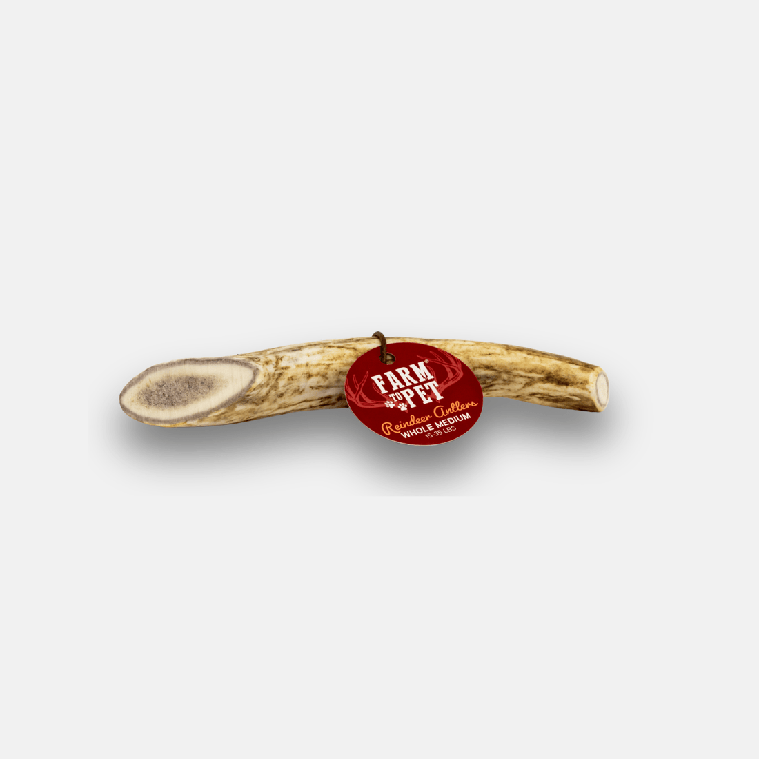 Organic reindeer antler dog chew from Farm To Pet, showing a whole antler with natural texture for medium-sized dogs.