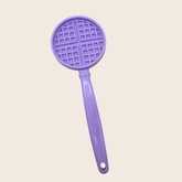 Close-up of Farm To Pet purple waffle lick stick, an interactive dog training toy designed for canine enrichment and mental stimulation.