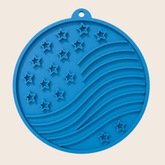 Blue round Farm To Pet dog lick mat with suction cups, featuring American flag design, for engaging pet feeding.