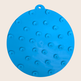 Blue round Farm To Pet dog lick mat with suction cups featuring an American flag design, designed to keep dogs entertained and calm.