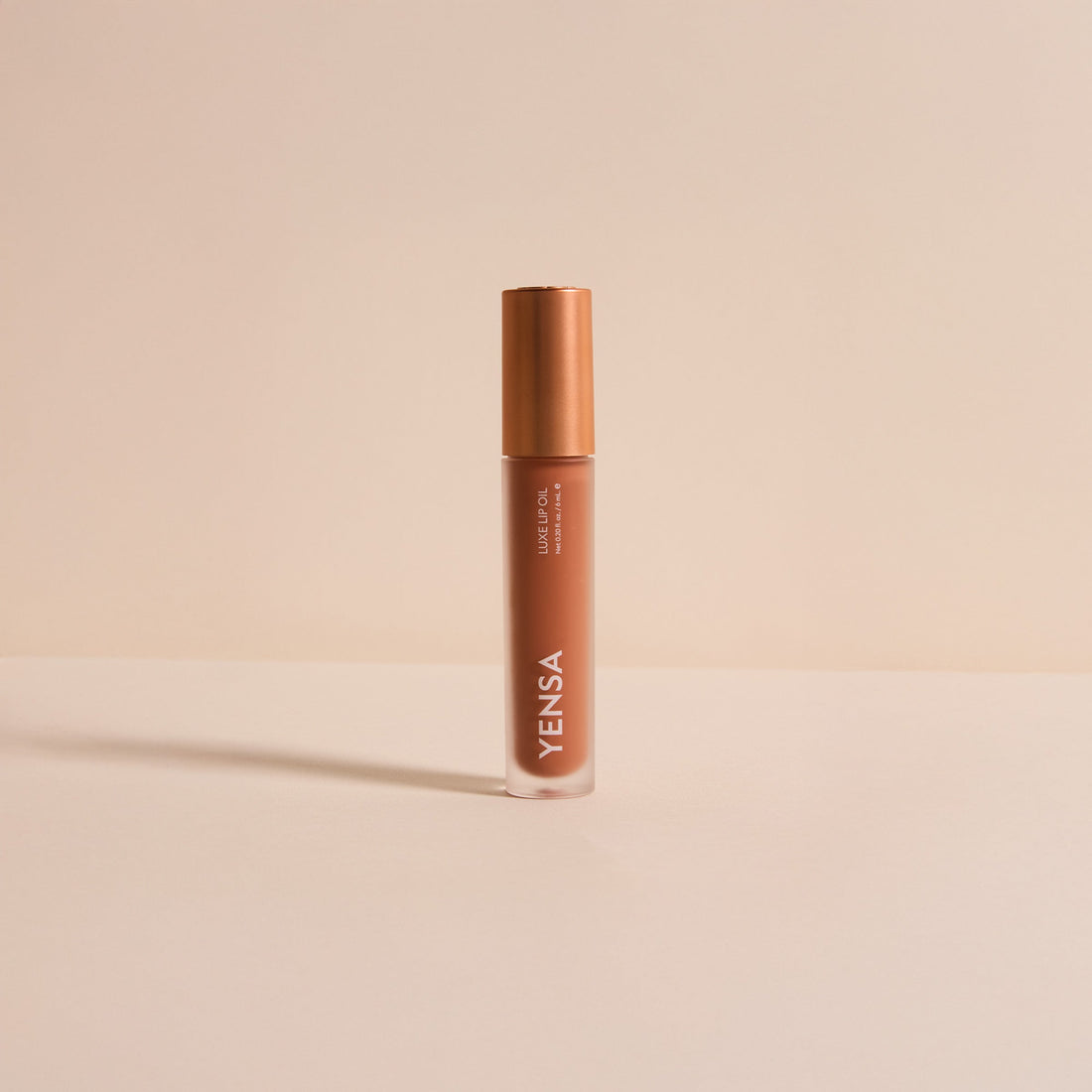 YENSA Luxe Lip Nourishing Oil with hyaluronic and vitamin E, featuring a clear lip oil bottle with a minimalist design.