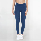 Black SmoothFit Crossover Leggings by Fitkitty Culture, stretchy athletic leggings for yoga and active wear, shown on a model.