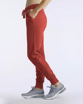 Goal Five Freasy Jogger in cinnabar color, lifestyle shot showing side view of comfortable jogger pants.
