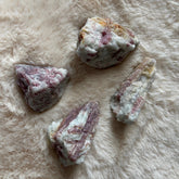 Raw pink tourmaline gemstone from Evermore Everlasting, showcasing its natural pink color and rough, unpolished texture.