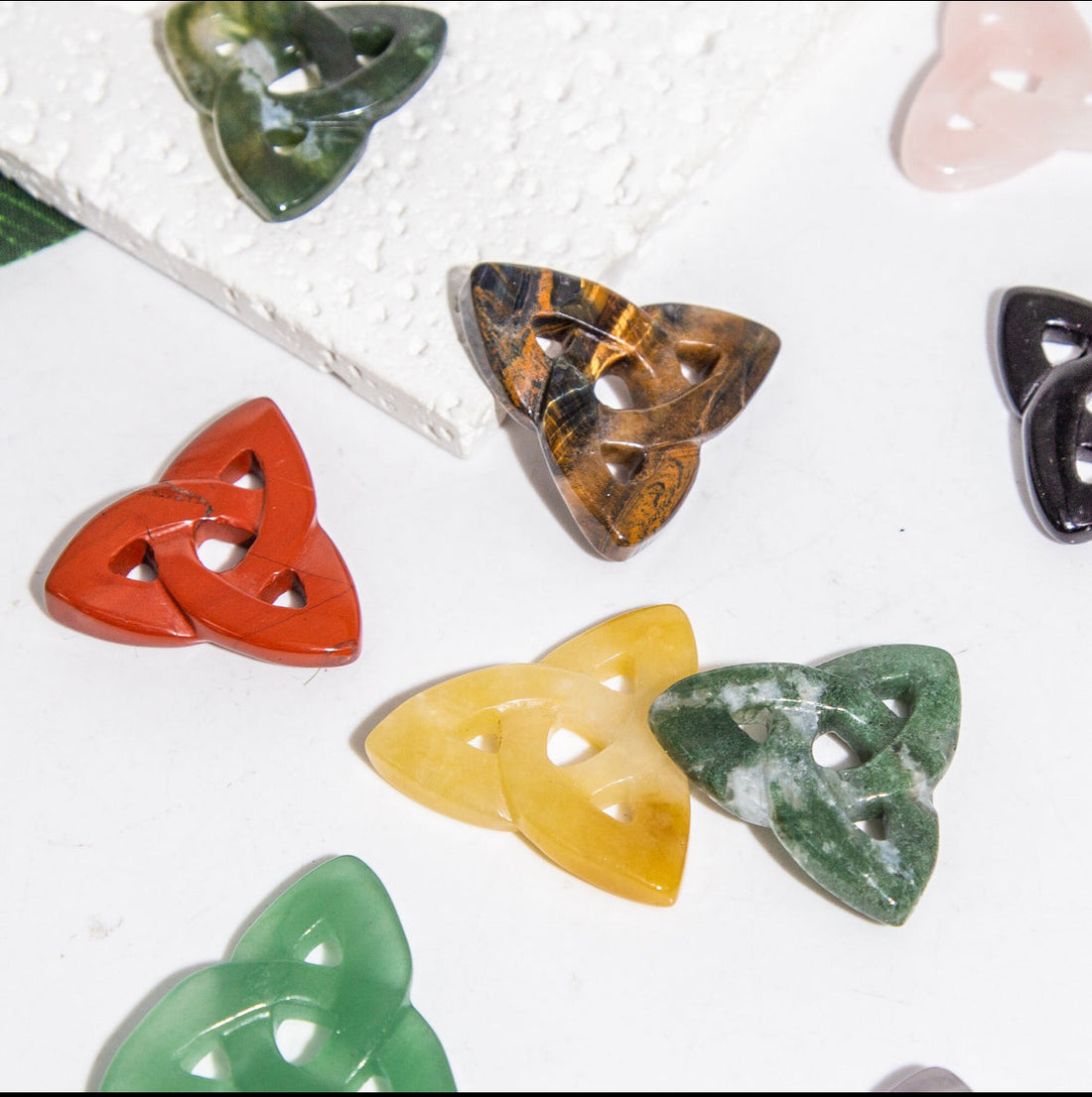 Carved crystal triquetra pendant by Evermore Everlasting, intricate design showcasing detailed craftsmanship and transparent crystal material.