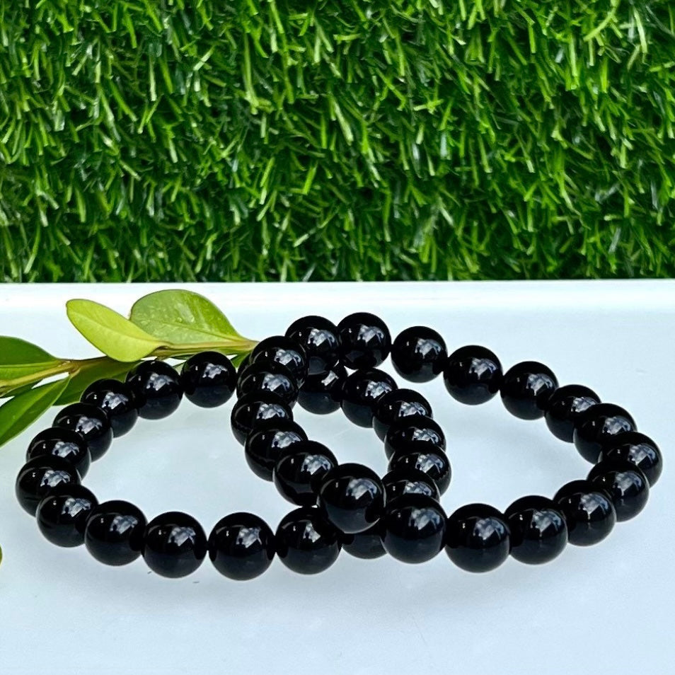 Onyx stretch bracelet with 10mm beads from Evermore Everlasting, featuring smooth black stones on an elastic cord.