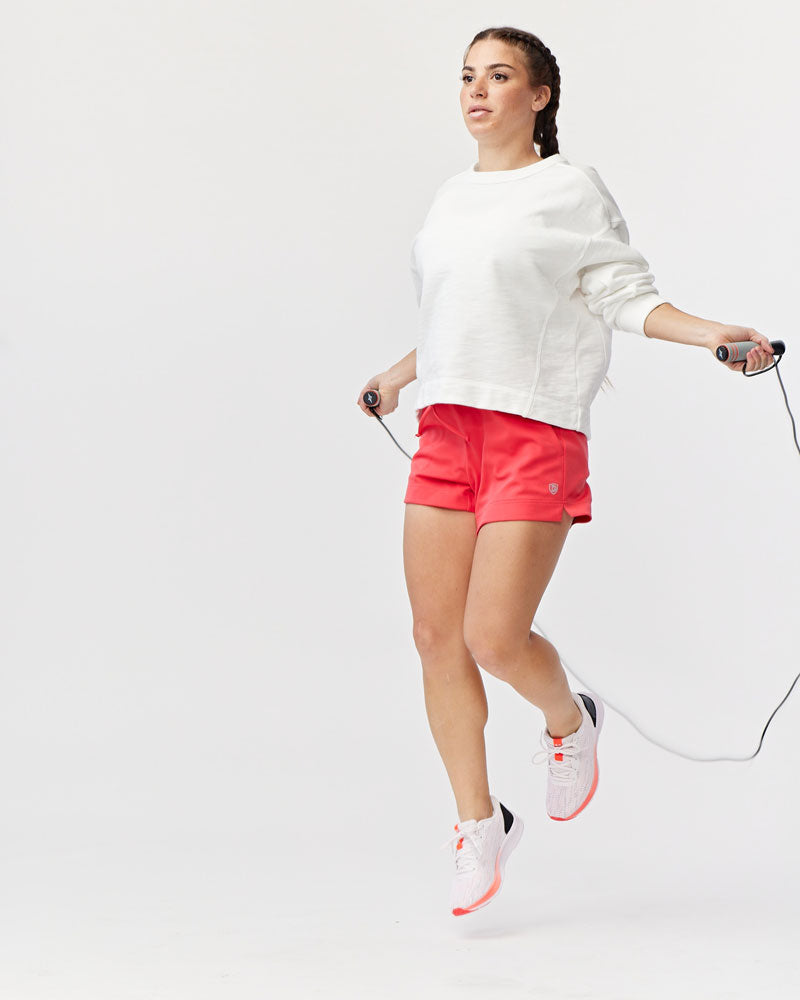 Goal Five G5 Advance 4.5-inch knit shorts in vibrant hot coral, featuring a comfortable elastic waistband and casual fit.