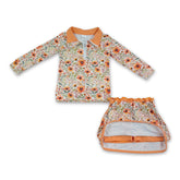 Girl in a long-sleeve mustard floral pullover and skirt set by Mini Rodeo, showcasing a cute, coordinated outfit for girls.