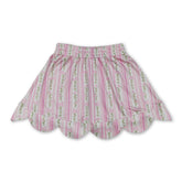 Pink floral elastic waist girl skirt with scalloped hem from Mini Rodeo, designed for girls, featuring a colorful floral pattern.