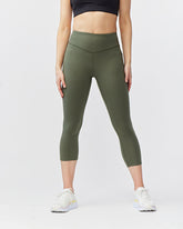 Dark moss green women’s cropped training leggings by Goal Five with 21-inch length, stretchy and comfortable for active wear.