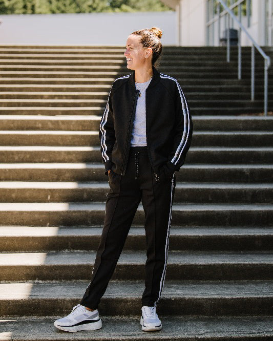 Goal Five Powerstripe LS Track Jacket in lifestyle setting, featuring sleek design and sporty style for active wear.