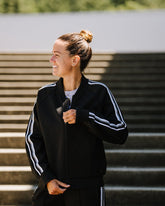 Goal Five Powerstripe LS Track Jacket in lifestyle setting, featuring sleek design and athletic fit, perfect for casual and active wear.