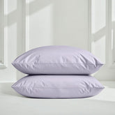 Italic Luxe Australian Sateen Sheet Set on a bed with white sheets and pillows in a cozy bedroom setting.