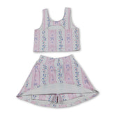 Pink floral girl’s sleeveless top and skirt set by Mini Rodeo, featuring bow accents and short sleeves for active wear.