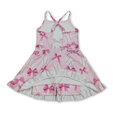 Pink bow baseball dress for girls, short sleeve summer athletic dress by Mini Rodeo with straps and playful design.