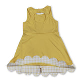 Yellow sleeveless scallop athletic dress for girls by Mini Rodeo, featuring a bow detail and short sleeve design.