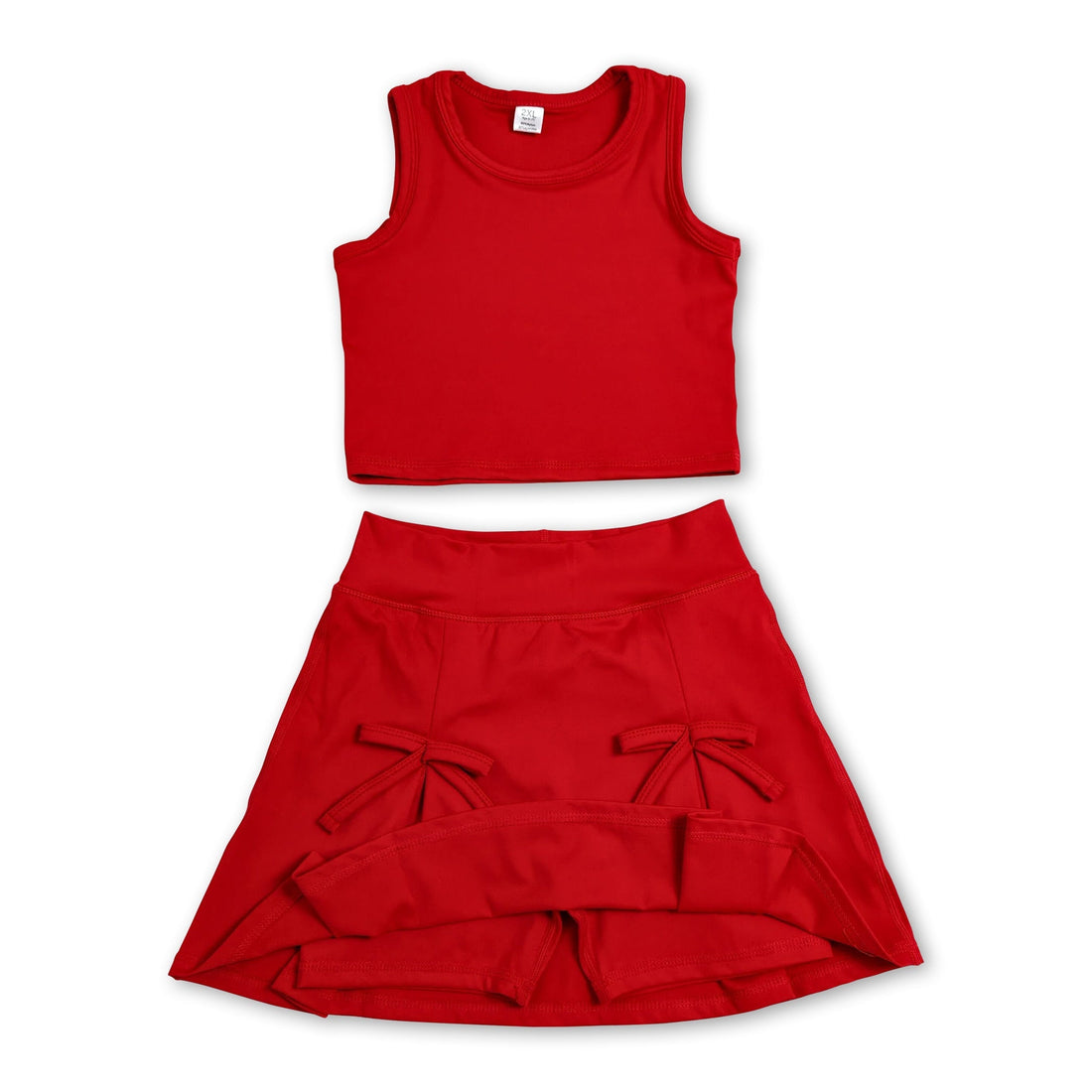 Red sleeveless girl’s active wear set with bow fold skirt and short sleeves by Mini Rodeo, perfect for active play.