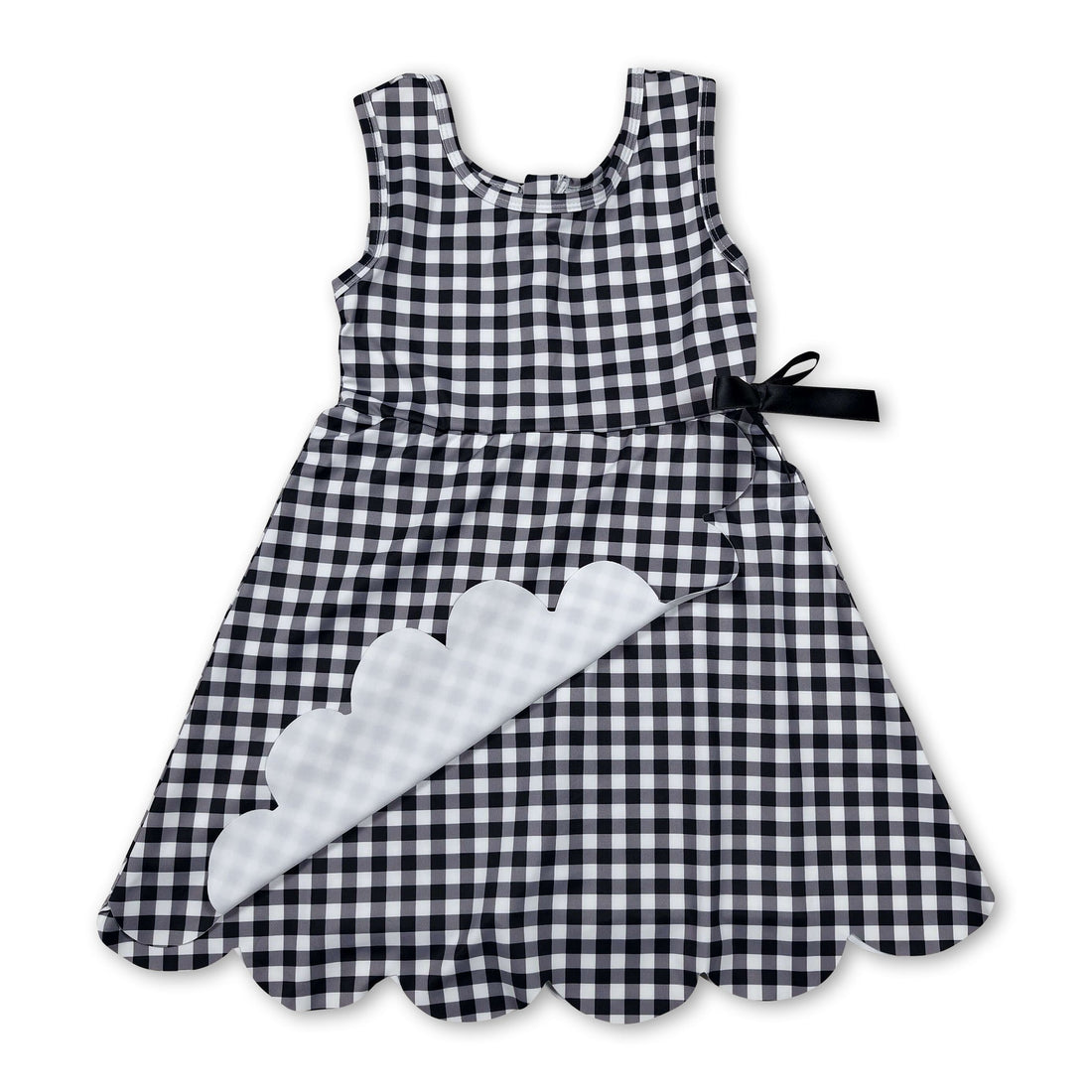 Sleeveless black plaid scallop athletic dress for girls by Mini Rodeo, featuring short sleeves and a cute scallop hem.