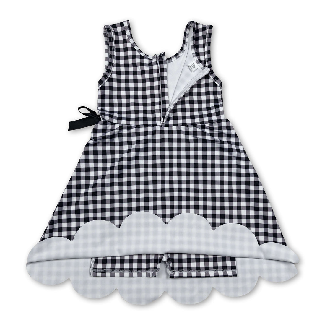 Black plaid scallop sleeveless athletic dress for girls by Mini Rodeo, featuring short sleeves and a playful scalloped hem.